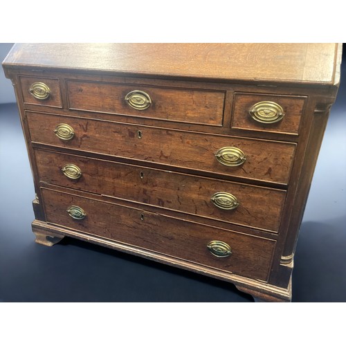 14 - A GEORGIAN OAK BUREAU. CURVED ARC COLUMNS AND BRASS HANDLES. FITTED DRAWER & PIGEON HOLE INTERIOR.
9... 