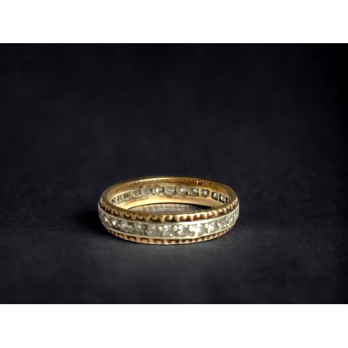 88 - A 9 carat gold & Diamond full eternity ring. 
Yellow & white gold band set with diamonds. 
Marked 9K... 