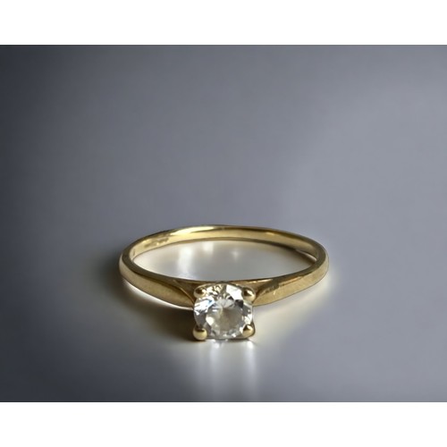 87 - A 9 carat gold and Cubic Zirconia engagement ring. 
Set with a round cut solitaire CZ.
UK Hallmarks.... 