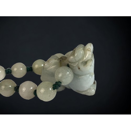 104 - A CHINESE CARVED JADE FO DOG BRACELET.