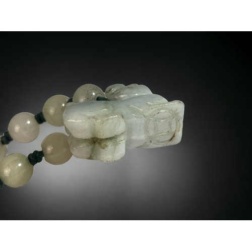 104 - A CHINESE CARVED JADE FO DOG BRACELET.