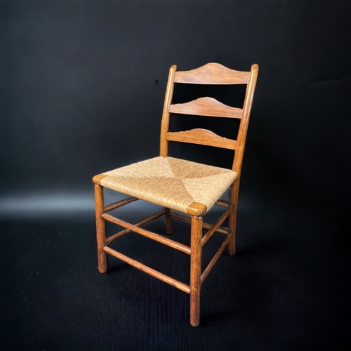 16 - A 19TH CENTURY ELM RUSH SEATED LADDER BACK CHAIR, TOGETHER WITH A RUSH WOVEN FOOTSTOOL. MAKERS MARK ... 