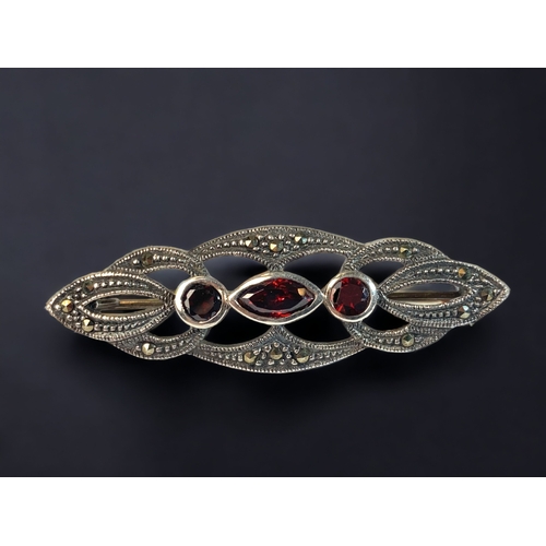 56 - A 925 SILVER LADIES RUBY AND MARCASITE BROOCH. 
45MM
