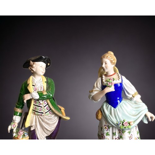 159 - A pair of Sitzendorf hand painted porcelain figures. 
Depicting Flower seller & sweetheart. 
24cm Ta... 