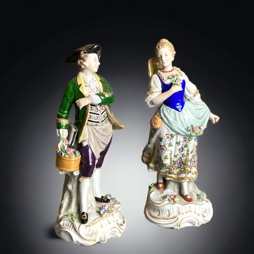 159 - A pair of Sitzendorf hand painted porcelain figures. 
Depicting Flower seller & sweetheart. 
24cm Ta... 