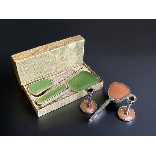 118 - A BOXED 1950's GUILLOCHE STYLE DRESSER BRUSH SET, TOGETHER WITH SIMILAR BRUSH AND CANDLESTICKS.