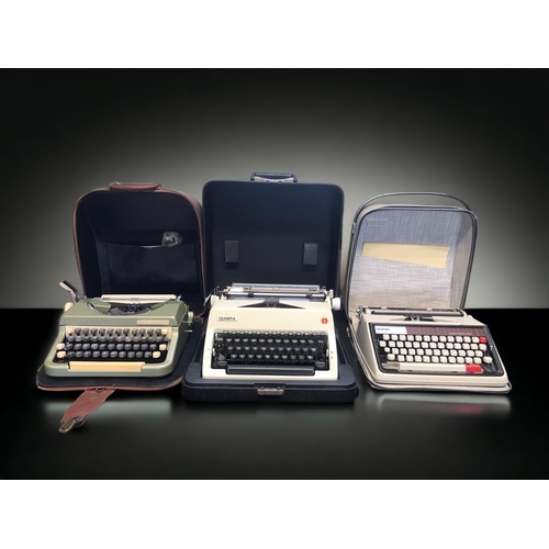 380 - THREE VINTAGE TYPEWRITERS. INCLUDING OLYMPIA, IMPERIAL & BROTHER. WITH CASES.