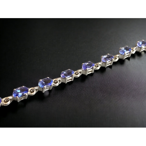 114 - A STERLING SILVER & TANZANITE LADIES BRACELET.
7.5