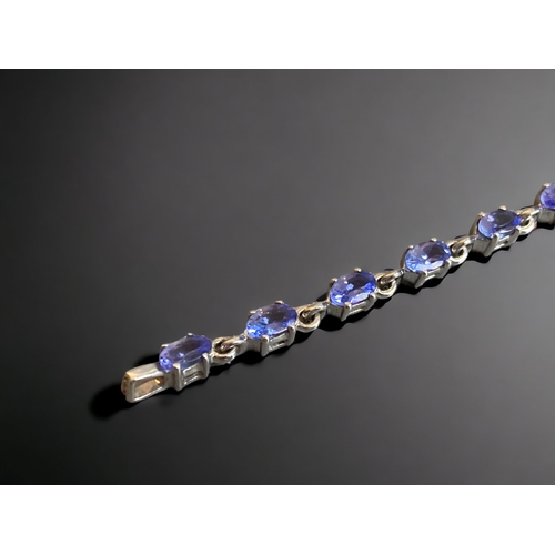 114 - A STERLING SILVER & TANZANITE LADIES BRACELET.
7.5