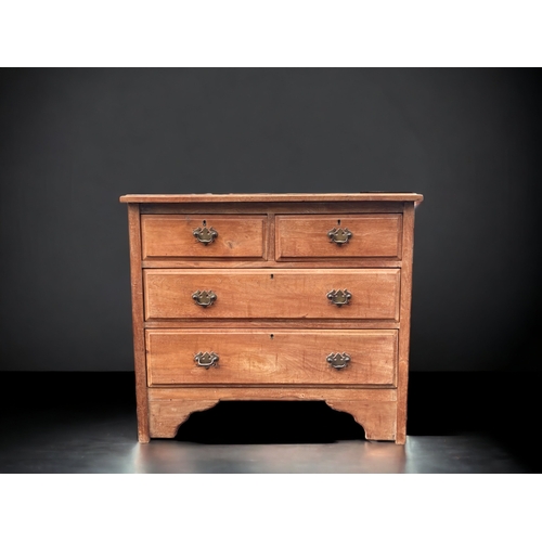 22 - A LATE VICTORIAN WAXED PINE FOUR DRAWER CHEST OF DRAWERS.