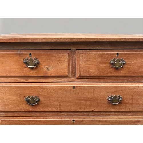 22 - A LATE VICTORIAN WAXED PINE FOUR DRAWER CHEST OF DRAWERS.