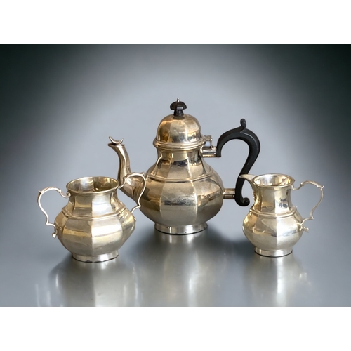 76 - AN ART DECO STERLING SILVER TEASET.
BY THOMAS BRADBURY & SONS. 
HEAVY GAUGE, WITH EBONY HANDLE & KNO... 