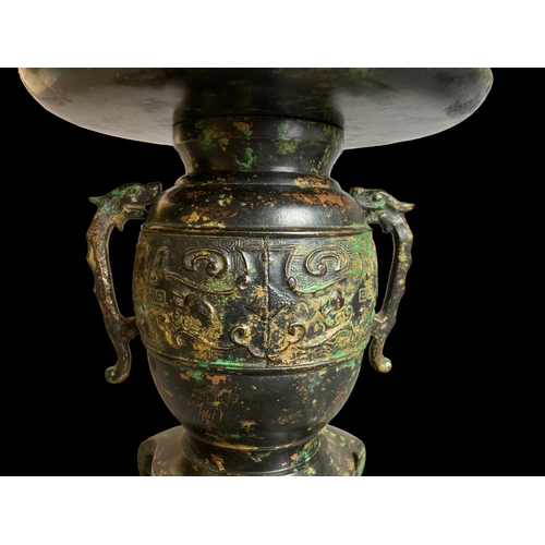 256 - A JAPANESE BRONZE USUBATA VASE. 
MEIJI PERIOD. 
DEPICTING TAOTIE MASK BAND AND DRAGON HANDLES. 
18 X... 