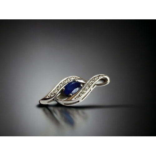 125 - A LADIES 10 CARAT WHITE GOLD, DIAMOND & SAPPHIRE PENDANT. 
22MM LONG.