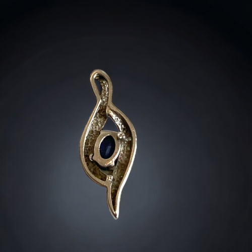 125 - A LADIES 10 CARAT WHITE GOLD, DIAMOND & SAPPHIRE PENDANT. 
22MM LONG.