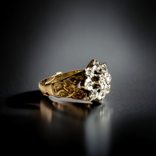 133 - A 9 CARAT GOLD & DIAMOND LADIES RING.
WHITE GOLD & DIAMOND FLOWER HEAD DESIGN, WITH YELLOW GOLD PEBB... 