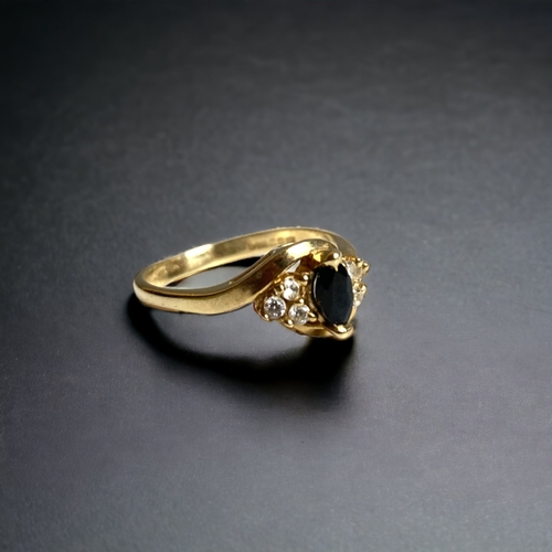 134 - A 9 CARAT GOLD, DIAMOND & BLUE STONE SET LADIES RING. UNKNOWN BLUE MARQUISE STONE, FLANKED BY DIAMON... 