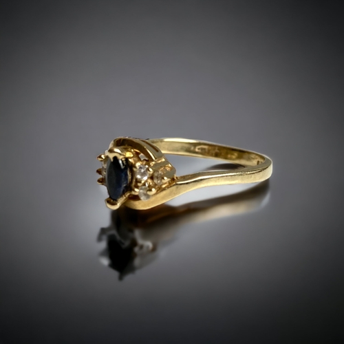 134 - A 9 CARAT GOLD, DIAMOND & BLUE STONE SET LADIES RING. UNKNOWN BLUE MARQUISE STONE, FLANKED BY DIAMON... 