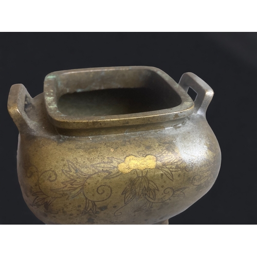 264 - A CHINESE BRONZE CENSER. WITH GOLD INLAY . 
QING DYNASTY.
DECORATED WITH FOLIATE DESIGNS. 
7.5 X 9 C... 