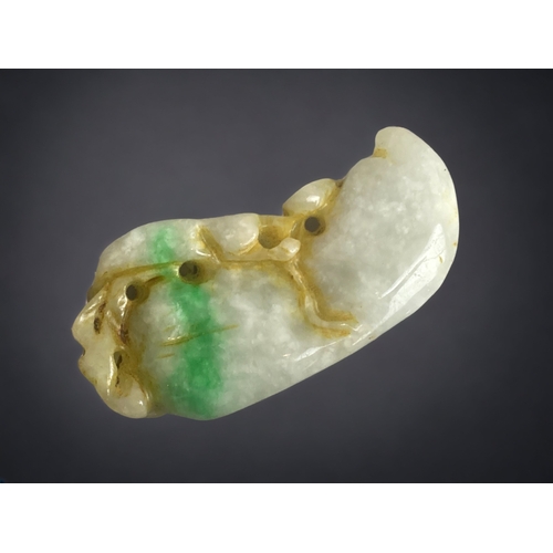 284 - A CHINESE BI COLOUR JADE CARVING. DEPICTING LILY PAD AND A SMALL ANIMAL. 
60MM LONG.