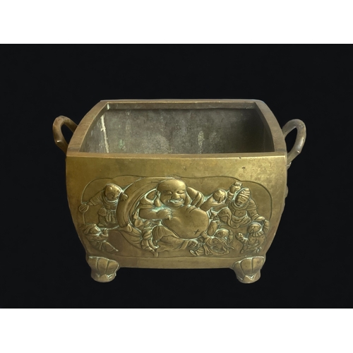 266 - A LARGE & HEAVY CHINESE BRONZE PLANTER.
DEPICTING BUDDHA & FIVE PLAYING CHILDREN TO ONE SIDE, AND MO... 