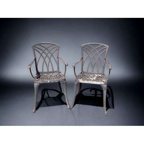 383 - A PAIR OF GREY CAST METAL GARDEN CHAIRS.