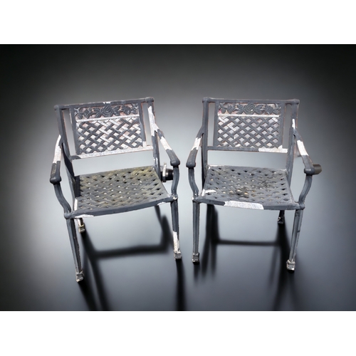 384 - A PAIR OF CAST METAL GARDEN CHAIRS.