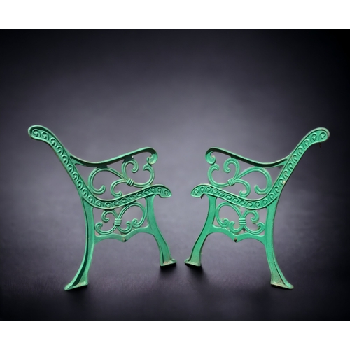 386 - A PAIR OF GREEN PAINTED CAST METAL GARDEN BENCH ENDS.