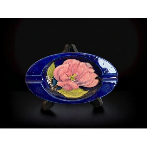 214 - A MOORCROFT MAGNOLIA ASH TRAY, TOGETHER WITH A LARGE MAW & CO ART NOUVEAU TILE. H.R JOHNSON.
TILE - ... 