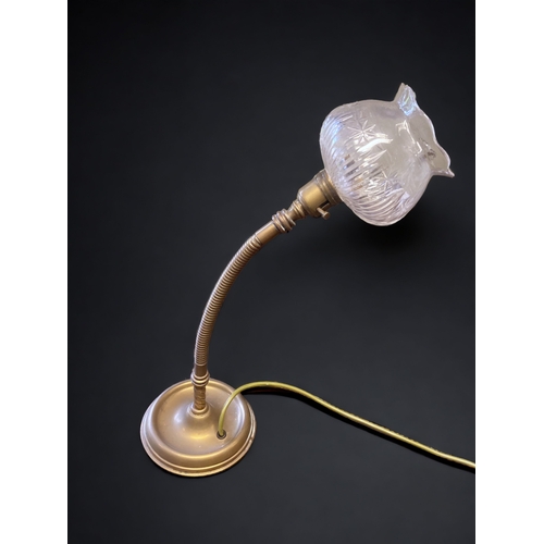 388 - AN EARLY 20TH CENTURY FRENCH BRASS 'BENDY' DESK LAMP. WITH CUT GLASS SHADE. 
49CM TALL.