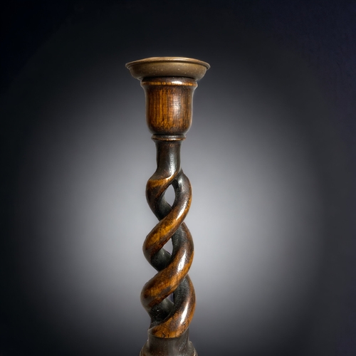 370 - A PAIR OF EARLY 20TH CENTURY WOODEN BARLY TWIST CANDLESTICKS. 
31.5CM TALL