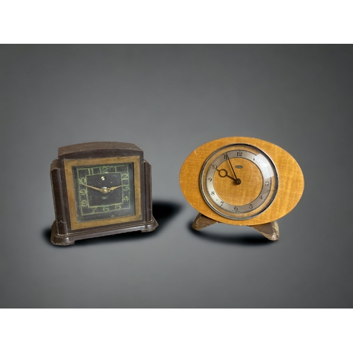 297 - A BAKELITE ART DECO ELECTRIC MANTLE CLOCK, TOGETHER WITH A SIMILAR METAMEC EXAMPLE.