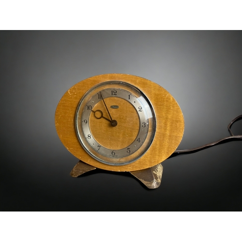 297 - A BAKELITE ART DECO ELECTRIC MANTLE CLOCK, TOGETHER WITH A SIMILAR METAMEC EXAMPLE.