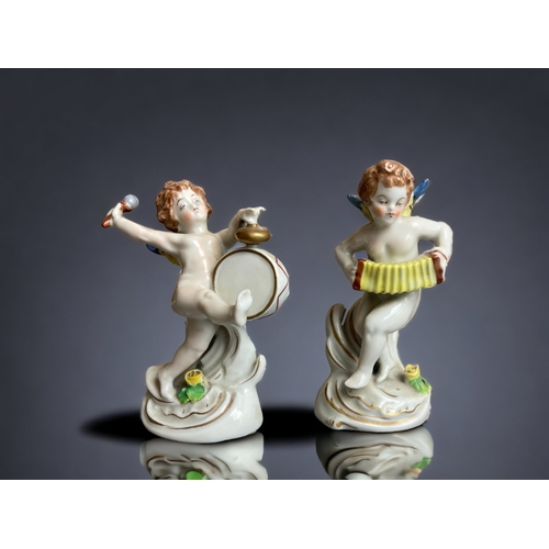 224 - A SET OF FOUR DRESDEN PORCELAIN CHERUB BAND FIGURES. EACH PLAYING A MUSICAL INSTRUMENT. 
TALLEST STA... 