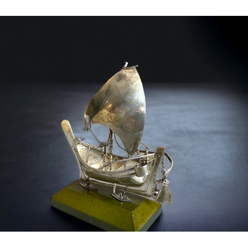 93 - A SILVER MODEL SHIP ON STAND.
9.5CM TALL. 
WEIGHT - 33.6G (WITHOUT STAND)