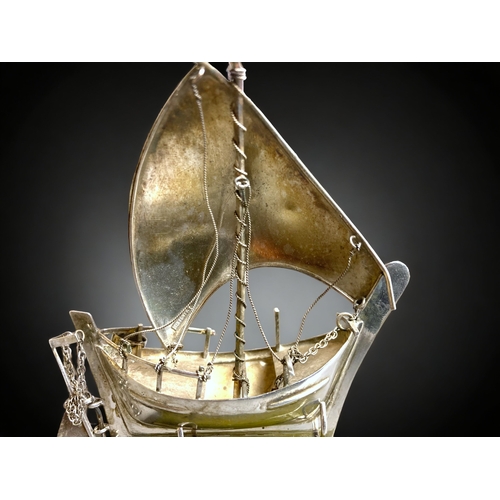 93 - A SILVER MODEL SHIP ON STAND.
9.5CM TALL. 
WEIGHT - 33.6G (WITHOUT STAND)