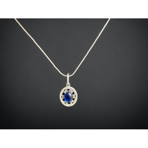 102 - A STERLING SILVER PENDANT NECKLACE. 
PENDANT SET WITH A BLUE STONE CABOCHON & BORDERED WITH ACCENT S... 