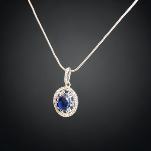 102 - A STERLING SILVER PENDANT NECKLACE. 
PENDANT SET WITH A BLUE STONE CABOCHON & BORDERED WITH ACCENT S... 