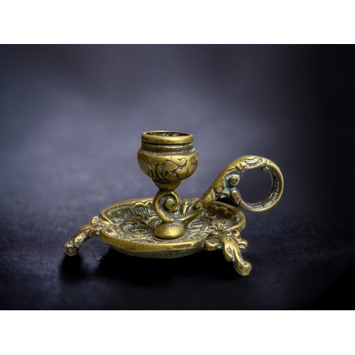 329 - A CONTINENTAL BRONZE CHAMBERSTICK.
6CM TALL