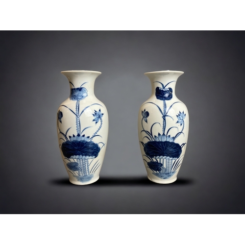 255 - A PAIR OF CHINESE HAND PAINTED PORCELAIN VASES. PAINTED WITH BLOSSOMING LILIES. 
21CM TALL.