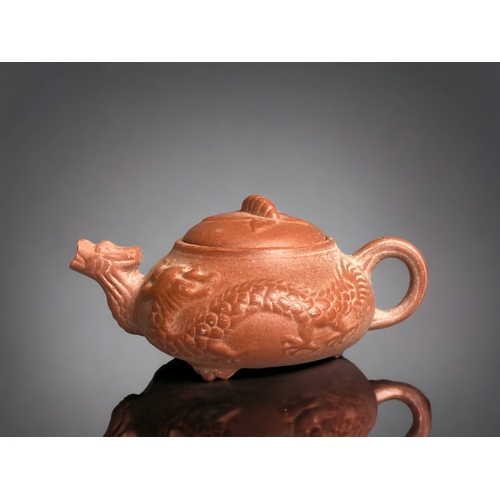 281 - A CHINESE YIXING POTTERY 'DRAGON' MINIATURE TEAPOT. 
4.5 X 11CM