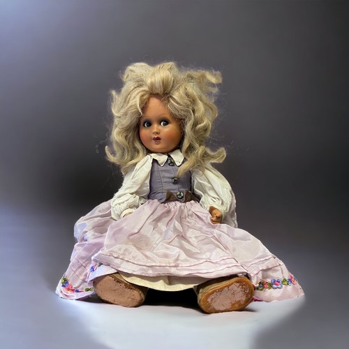 437 - A VINTAGE COMPOSITE DOLL.
WITH CRIER.