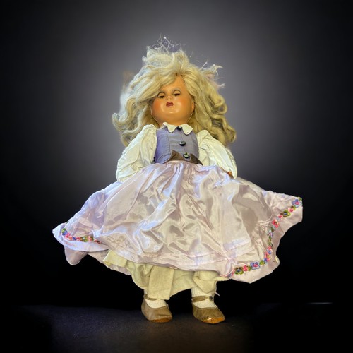 437 - A VINTAGE COMPOSITE DOLL.
WITH CRIER.