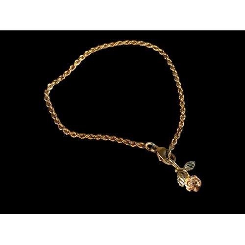 120 - A 9ct Gold Rope Bracelet and flower Charm. 4g