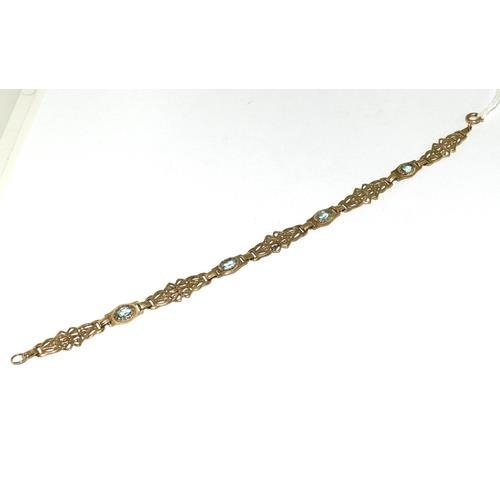 59 - A 9ct Gold Ladies Fancy Link Aquamarine Bracelet. Weight - 6g