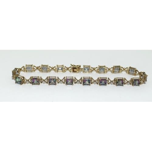 112 - 9ct gold ladies Mystic Topaz line bracelet 21cm long 9.5g