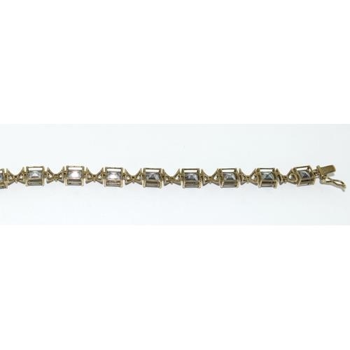 112 - 9ct gold ladies Mystic Topaz line bracelet 21cm long 9.5g