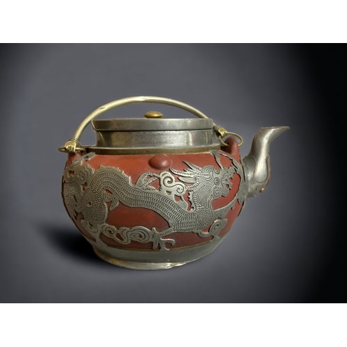 305 - A CHINESE PEWTER OVERLAY YIXING TEAPOT. 
EARLY 20TH CENTURY.
DEPICTING DRAGONS CHASING THE PEARLY AM... 