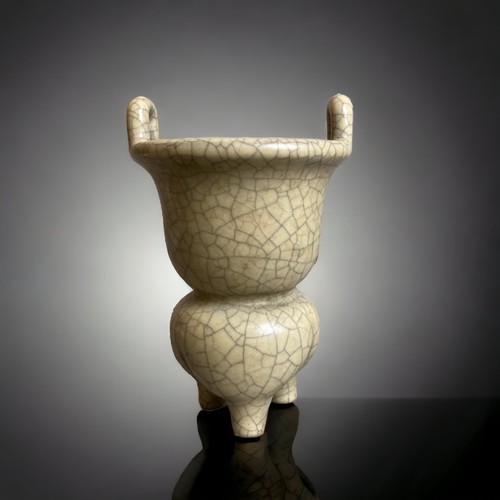 306 - A CHINESE GUAN TYPE TRIPOD CENSER.
GOURD SHAPE WITH LOBED TRIPOD FORM BASE AND TWIN HANDLES TO BOWL.... 