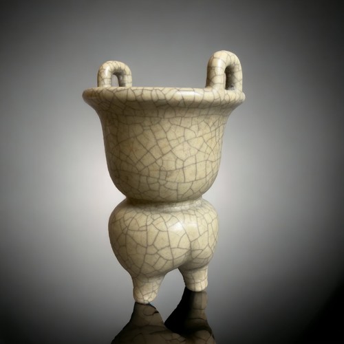 306 - A CHINESE GUAN TYPE TRIPOD CENSER.
GOURD SHAPE WITH LOBED TRIPOD FORM BASE AND TWIN HANDLES TO BOWL.... 